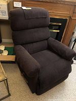 Front and side views of La-Z-Boy manual rocking recliner chair showing dark brown corduroy fabric upholstery and padded cushions.