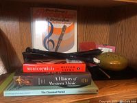 Plastic soprano recorder, Steel tongue drum, five music books including 'Music Through Recorder' method book, 'Musicophilia' by Oliver Sacks, 'A History of Western Music', 'Anthology of Piano Music Volume II', and 'The Classical Period' book