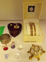 View of all items in the lot including Anne Klein jewellery box, decorative boxes, glass trinkets, and turtle figurine.