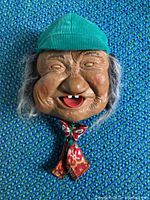 Front view of Peter animatronic head on blue fabric background