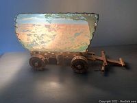 Front angle view showing the wooden covered wagon lamp, illuminated shade with painted outdoor scene