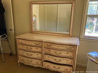 Front view of the French Provincial eight drawer dresser with attached mirror showing the intricate painted details and overall condition.