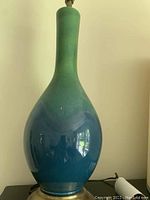 Full view of ombré ceramic lamp base showing gradient blue to green finish and brass base.