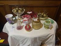 View of entire 12-piece antique and vintage glassware lot on white cloth.