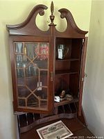 Front view of vintage Georgian design secretary desk with glass cabinet doors open, showing shelves and interior compartments.
