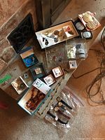 Overview of the vintage costume jewelry collection showing boxes with various items including earrings, brooches, necklaces, watches, shoe clips, and compacts.