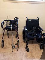 Photo showing the wheelchair and walker side by side, including the quad cane accessory in the front view.