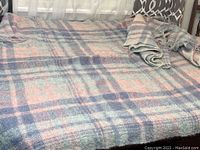 View of one blanket spread out showing the pastel plaid pattern and soft textured fabric.