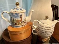 Front side of the teapot with Big Ben and Houses of Parliament, and the nesting teacup beside it, highlighting the gilded lid knobs and overall condition.