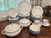 Full overview of the 45-piece dinnerware set on dining table, showing largest items and small bowls.