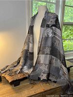 Full view of the silk blend wrap draped on a mannequin showing the star and Marilyn Monroe pattern, fringed edges visible.