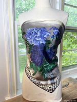 Front view of the vintage Perry Ellis silk scarf on a mannequin showing the large blue floral pattern and the netted border.