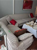 Corner view showing full two-piece sectional and adjacent dining table