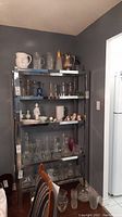Full frontal view of mirrored shelving unit with items on shelves