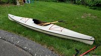 Left side view of kayak on grass showing full length, cockpit and bungee cords