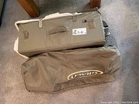 Two soft carrying bags with Graco logo for the portable playard and its accessories