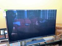 Front view of the Panasonic 55-inch plasma TV powered off on a stand.