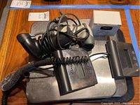 Two Escali S100 digital scales, one with a Cracktown sticker on the weighing platform, with two handheld barcode scanners and a small white box on a wooden table.