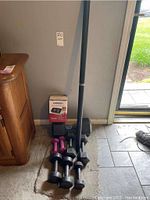 Photo showing all weights and Omron blood pressure monitor box on floor by wall.