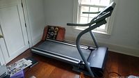 Full side view of NordicTrack APEX 5100i treadmill, showing running surface and frame