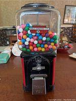 Front view of vintage Folz Vending Co. gumball dispenser filled with colorful gumballs.