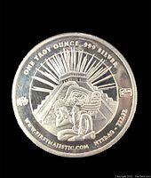 Top side of silver coin showing Aztec/Mayan figure and pyramid design, with purity and weight markings.