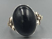 Close-up of the ring's black onyx stone and side 10Kt gold details