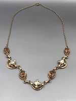 Full view of the necklace showing design and chain