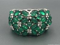 Front view of the sterling silver jade ring showing green jade stones and silver floral details