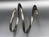 Side view of the sterling silver snake bracelet showing the spiral wrap shape.