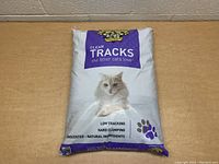 Full view of the 40 lbs bag showing cat image and product claims of low tracking, hard clumping, unscented natural ingredients.