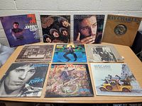 Photo showing 10 vinyl LP records including Johnny Cash, The Beatles, Bruce Springsteen, Ray Charles, Bob Dylan, The Beach Boys.