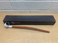 Photo of vintage Gstar long stem pipe displayed alongside original black Gstar box with logo.