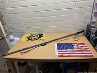 Xprite whip light laid out on table with American flag and wiring visible