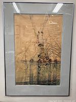 Framed watercolor artwork showing entire image with birds, reeds, and water reflections, glass with visible cracks in left corners.