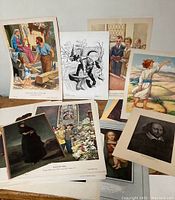 Collection of loose art prints arranged showing various subjects including historical, religious and pastoral scenes
