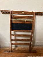 Full front view of the oak pool cue holder with scoreboard and chalkboard panel.