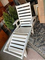 White vintage Grosfillex resin patio lounge chair with horizontal slat design, adjustable reclining back and fold-out footrest shown from multiple angles.
