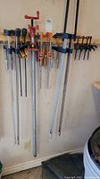 Full view of all clamps hung on two boards, showing variety and arrangement