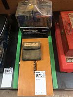 Photo of lot containing Mastercraft 101-piece drill and screwdriver bit set in plastic packaging and Rockler drill bit set in fabric pouch on board.