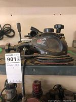 Side view of the Black & Decker electric sander showing the power cord wrapped around it.