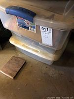 Plastic storage bins stacked with blue and white handles, labeled '3 bins & tools'.