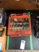 Red plastic Mastercraft Maximum case with transparent lid showing stored router bits