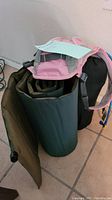 Camelbak hydration backpack and green rolled air mattress