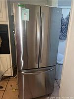 Front view of stainless steel French door refrigerator with bottom freezer drawer