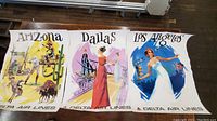 Three Delta Airlines destination posters for Arizona, Dallas, and Los Angeles laid out on floor showing full designs and condition
