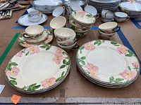 Photo showing full set of 20 Franciscan dinnerware pieces including plates, teacups, and saucers with pink floral design and gold trim.