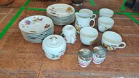 Full set of Royal Worcester Evesham dinnerware including plates, cups, sugar bowl, creamers, and egg coddlers arranged on table.