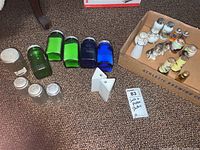 Five vintage salt and pepper shakers on carpet with additional various shakers in background