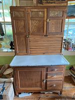 Front view closed upper doors, roll-top, enamel work surface, bottom cabinet and drawers